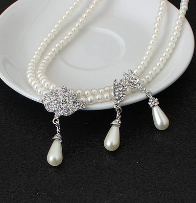 Two-strand faux pearl necklace with a rhinestone lotus pendant and matching teardrop pearl dangle earrings. - Image 4
