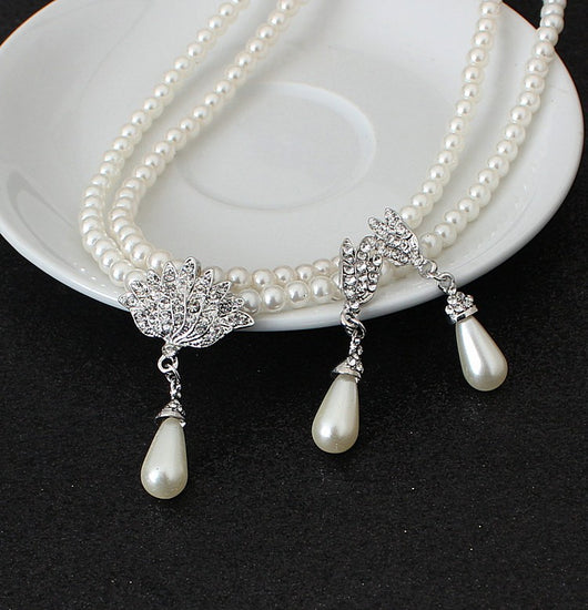 Two-strand faux pearl necklace with a rhinestone lotus pendant and matching teardrop pearl dangle earrings. - Image 4