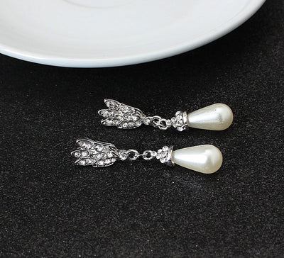 Two-strand faux pearl necklace with a rhinestone lotus pendant and matching teardrop pearl dangle earrings. - Image 5