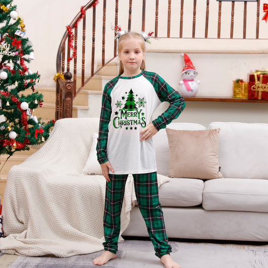 Family of four wearing matching green plaid Christmas pajamas with "Merry Christmas" and Christmas tree print. - Image 7
