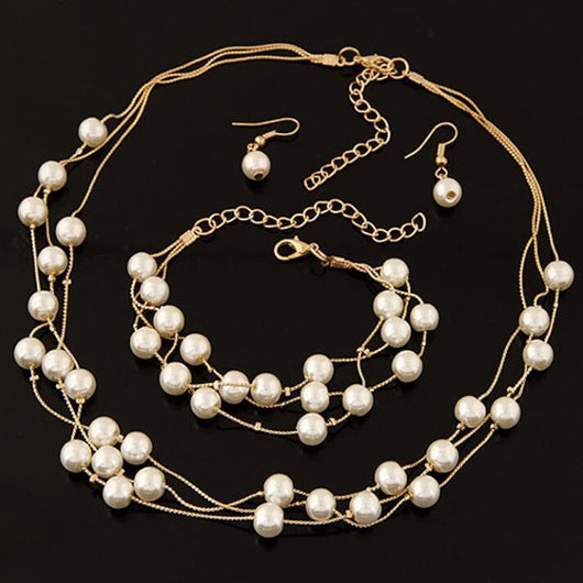 Elegant three-piece jewelry set with multi-strand pearl necklace, matching bracelet, and pearl drop earrings. - Image 2