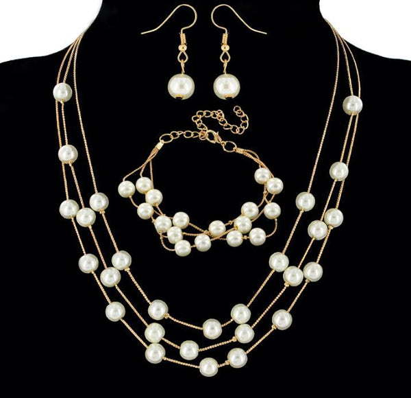 Elegant three-piece jewelry set with multi-strand pearl necklace, matching bracelet, and pearl drop earrings. - Image 5