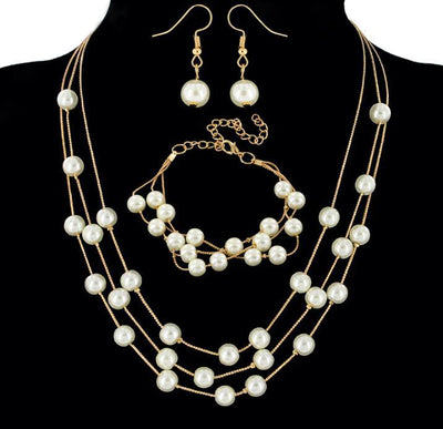 Elegant three-piece jewelry set with multi-strand pearl necklace, matching bracelet, and pearl drop earrings. - Image 5