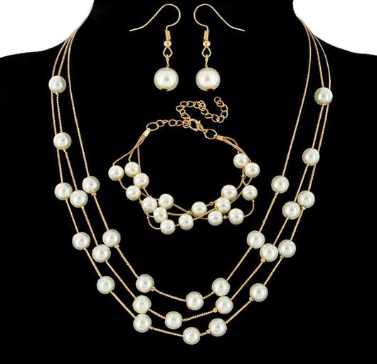 Elegant three-piece jewelry set with multi-strand pearl necklace, matching bracelet, and pearl drop earrings. - Image 5
