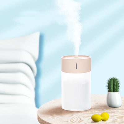 Cylindrical humidifier with a frosted white body and a light pink top, featuring a small mist outlet. - Image 2