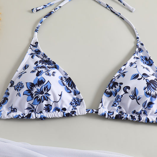 White and yellow floral print three-piece bikini set with a halter triangle top, high-cut bottom, and sheer white sarong. - Image 11
