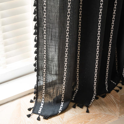 Black polyester curtain with white jacquard multi-line pattern and black tassels, draped over a white chair. - Image 25