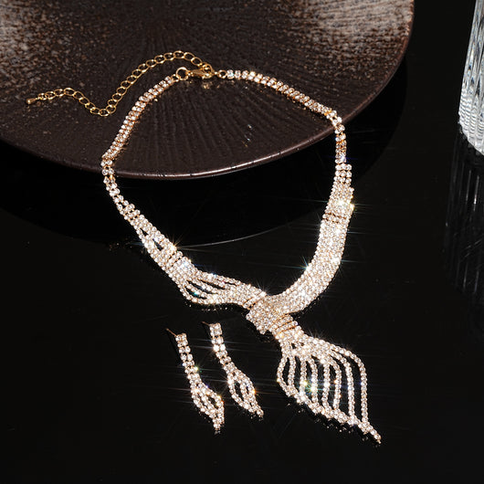 Gold-tone rhinestone necklace and matching dangle earrings set. The necklace features a multi-strand, leaf-like design. - Image 10