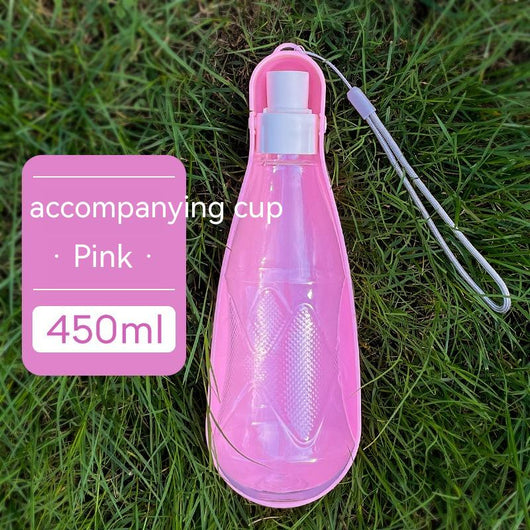 Yellow 450ml portable pet water bottle with a folding drinking trough and white wrist strap, on grass. - Image 8