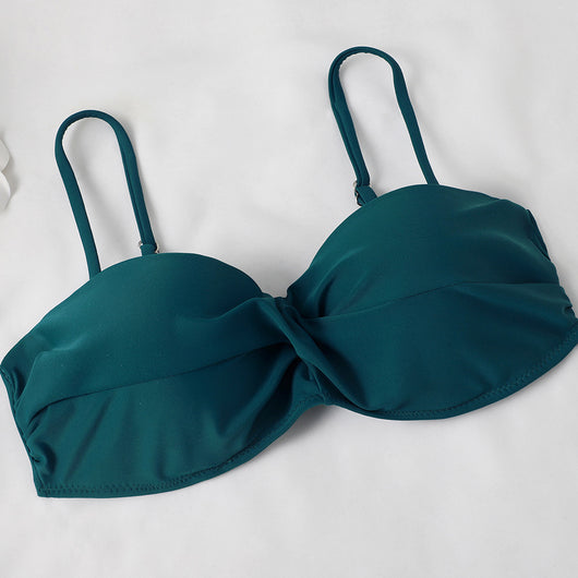 Teal twisted bandeau bikini top with tropical leaf print high-waisted bottoms on a model wearing a white shirt. - Image 13