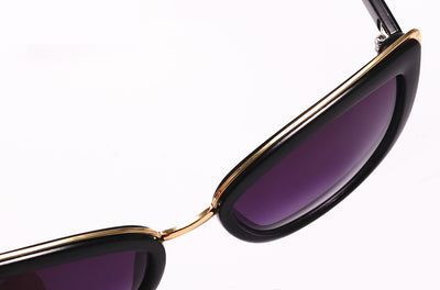 Black cat-eye sunglasses for women with gradient grey lenses and subtle gold-tone metal accents on the frame. - Image 15