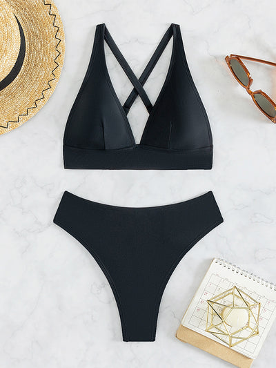Bright blue two-piece bikini with a V-neck halter top and high-cut bottoms on a woman at the beach. - Image 25