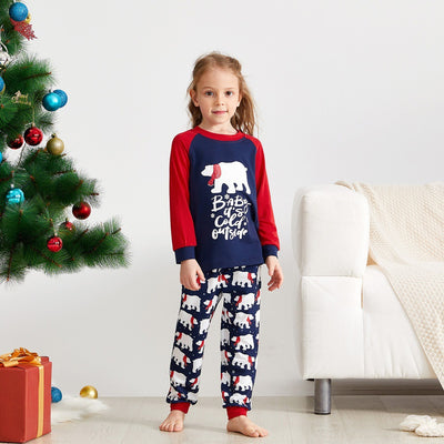 Child wearing dark blue and red Christmas pajamas with polar bear print and "Baby it's cold outside" text. - Image 9