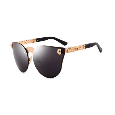 Pink mirrored cat-eye sunglasses with gold-toned frames, skull, and floral embellishments on the temples. - Image 3