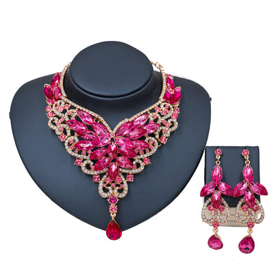 Exaggerated green gemstone necklace and matching dangle earrings set with gold-tone metal and clear accents. - Image 10