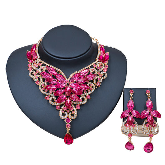 Exaggerated green gemstone necklace and matching dangle earrings set with gold-tone metal and clear accents. - Image 10