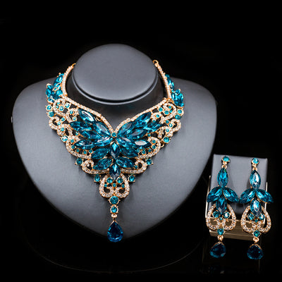 Exaggerated green gemstone necklace and matching dangle earrings set with gold-tone metal and clear accents. - Image 4