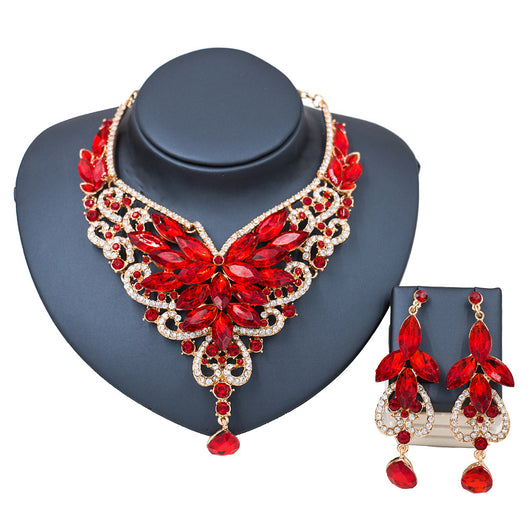 Exaggerated green gemstone necklace and matching dangle earrings set with gold-tone metal and clear accents. - Image 6