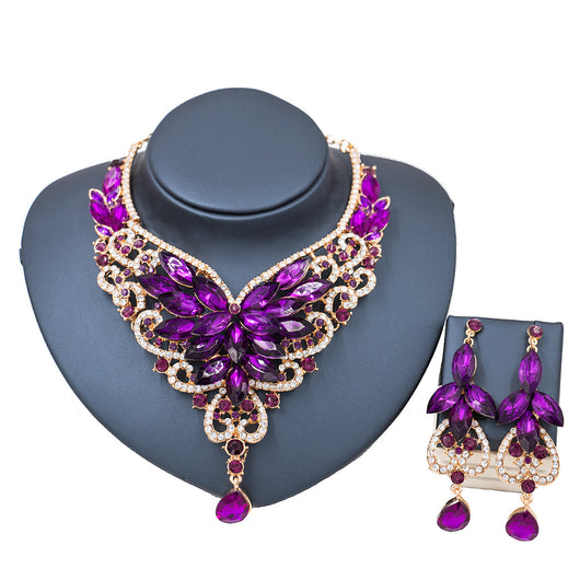 Exaggerated green gemstone necklace and matching dangle earrings set with gold-tone metal and clear accents. - Image 9