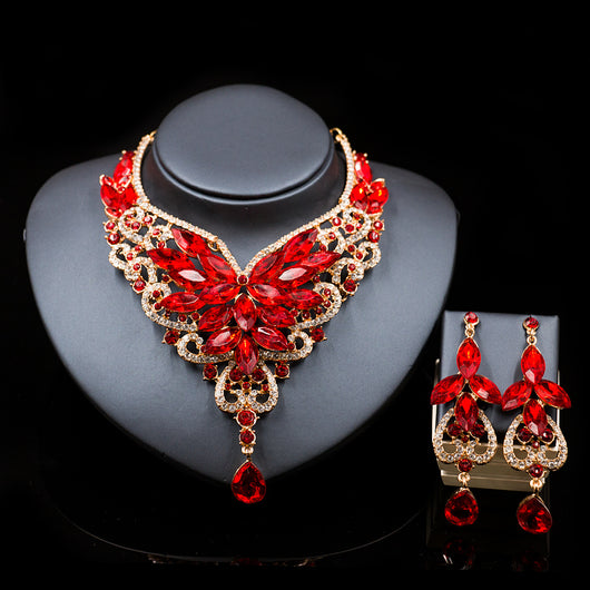 Exaggerated green gemstone necklace and matching dangle earrings set with gold-tone metal and clear accents. - Image 3