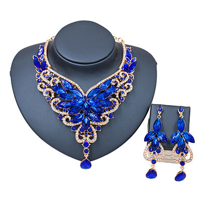 Exaggerated green gemstone necklace and matching dangle earrings set with gold-tone metal and clear accents. - Image 8