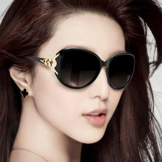 Brown oversized women's sunglasses with gradient lenses and gold-tone fox head embellishments on the temples.