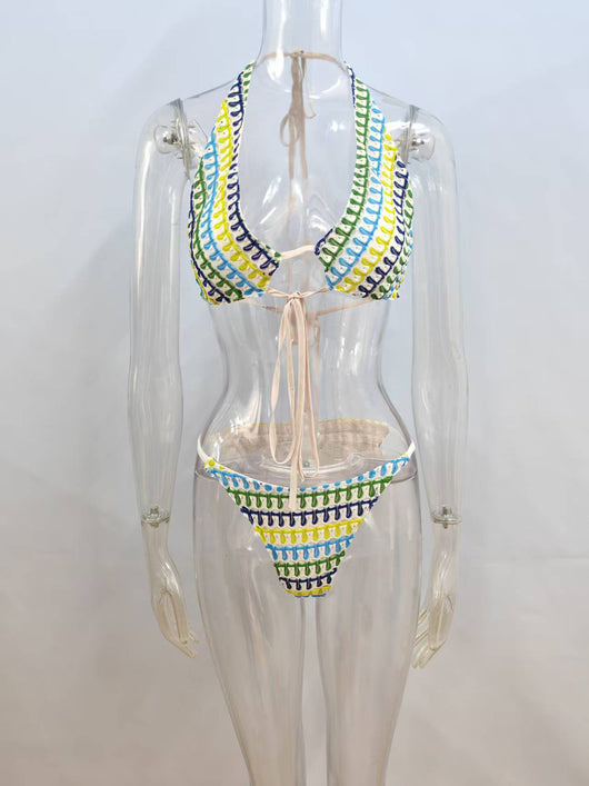 Woman in a blue, green, and yellow patterned halter bikini top and matching flowy sarong on a sunny beach. - Image 5