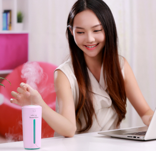 White mini USB ultrasonic humidifier with a green LED light strip, emitting mist, on a white surface. - Image 3