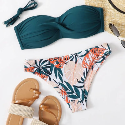 Blue bandeau bikini top with tropical leaf print high-cut bottom, styled with sandals, sunglasses, and a straw hat. - Image 3