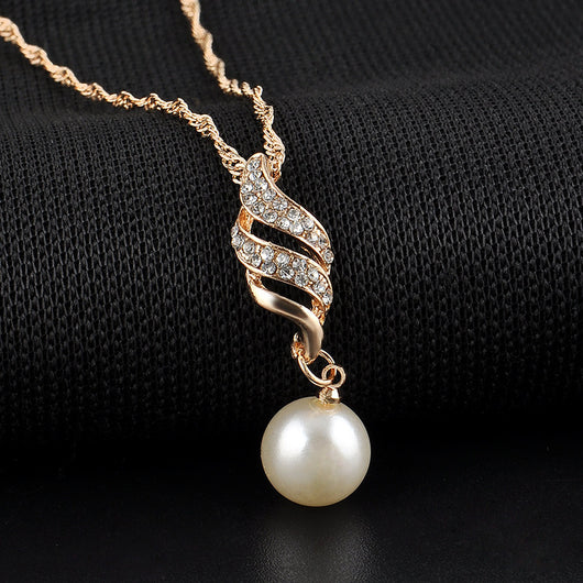 Gold-tone necklace and dangle earring set with faux pearls and clear rhinestones, displayed on a black bust. - Image 3