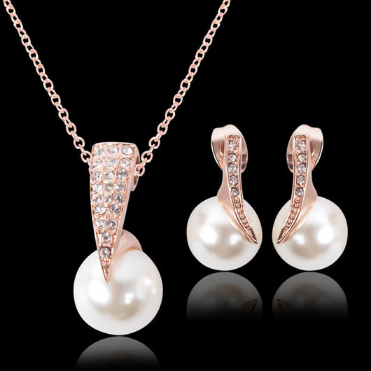 Rose gold-toned necklace and drop earrings set with white spherical pearls and clear rhinestone accents. - Image 8