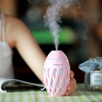 Light green football-shaped humidifier with a decorative lattice pattern and a power button on top. - Image 6