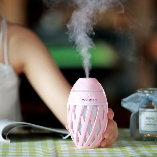 Light green football-shaped humidifier with a decorative lattice pattern and a power button on top. - Image 6