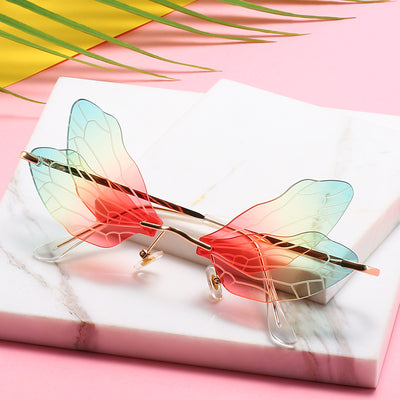 Dragonfly wing sunglasses with gold metal frames and unique brown tinted rimless lenses, suitable for adults. - Image 2