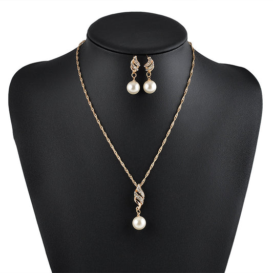 Gold-tone necklace and dangle earring set with faux pearls and clear rhinestones, displayed on a black bust. - Image 2