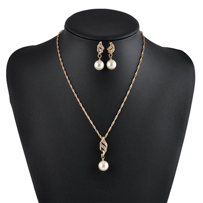 Gold-tone necklace and dangle earring set with faux pearls and clear rhinestones, displayed on a black bust. - Image 2