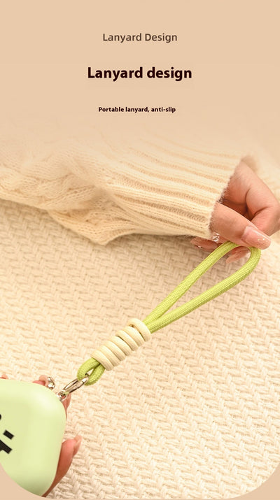 Light green square hand warmer with rounded corners and a black smiley face, hanging from a two-tone lanyard. - Image 16