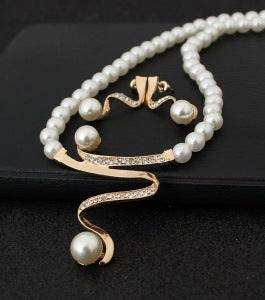 White pearl necklace and matching stud earrings set with gold-tone wavy metal and clear crystal accents. - Image 2