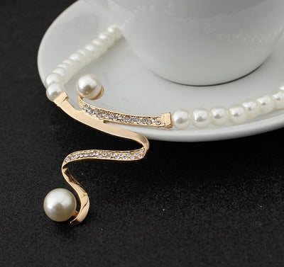 White pearl necklace and matching stud earrings set with gold-tone wavy metal and clear crystal accents. - Image 4