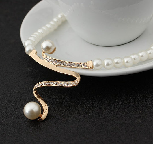 White pearl necklace and matching stud earrings set with gold-tone wavy metal and clear crystal accents. - Image 4