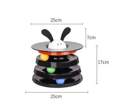 Brown tabby cat sniffing a black and orange multi-level rotating cat plate toy with colorful balls and bunny ears. - Image 13