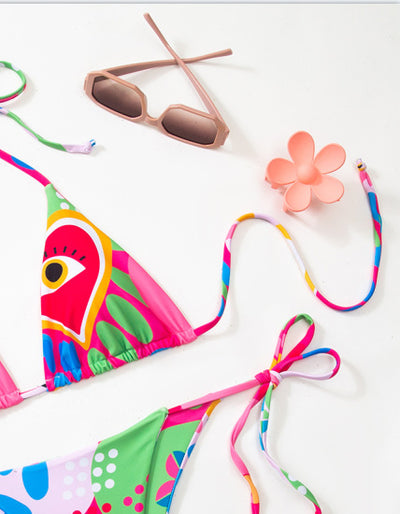 Women's vibrant abstract eye print bikini with triangle top and tie-side bottoms, featuring pink, green, and blue. - Image 13