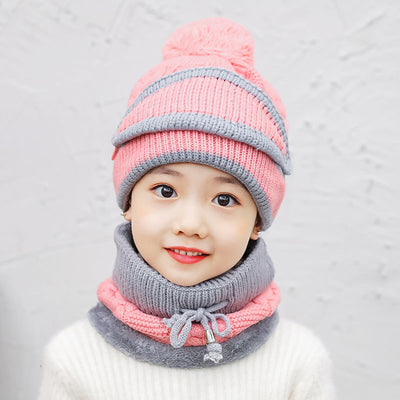 Young child wearing a pink and grey knitted hat with a pom-pom and a matching neck warmer with a drawstring. - Image 10