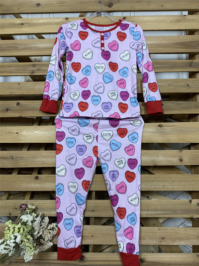 Pink long-sleeve pajama set with a conversation heart print, red Henley neckline, and matching full-length pants. - Image 6