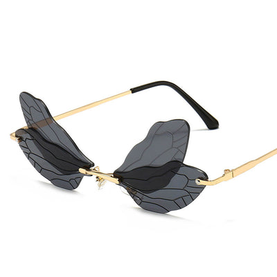 Frameless sunglasses with pink and orange-yellow dragonfly wing-shaped lenses and gold-colored metal temples. - Image 3