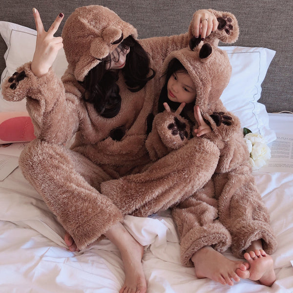 Parent and child wearing matching gray coral fleece hooded homewear sets with animal ears and paw print details.