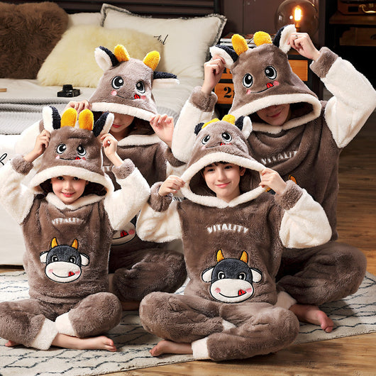Family wearing matching black and white panda plush housewear suits with hoods and checkered pants, posing indoors. - Image 11