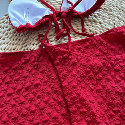Red textured three-piece women's swimsuit set with triangle bikini top, thong bottom, and matching mini skirt. - Image 22