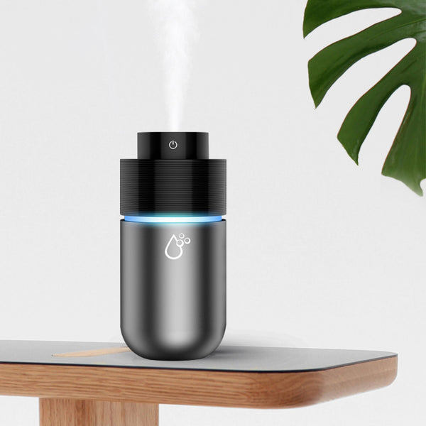 White car mini spray air purifying humidifier with a yellow light ring and a power button icon.