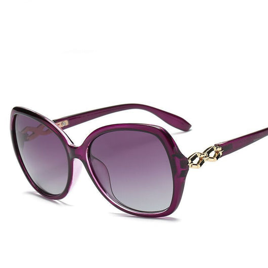 Women's purple oversized polarized sunglasses with gradient lenses and gold chain link detail on the temples. - Image 4